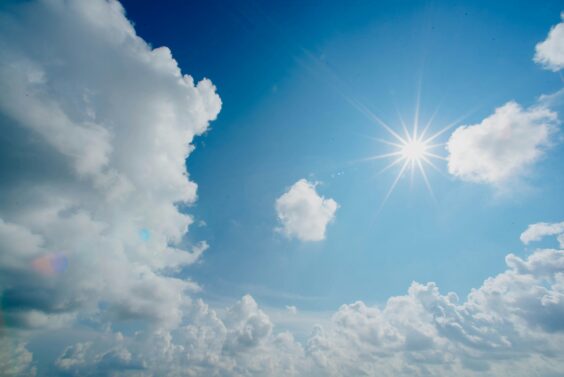 Sun on a blue sky with clouds